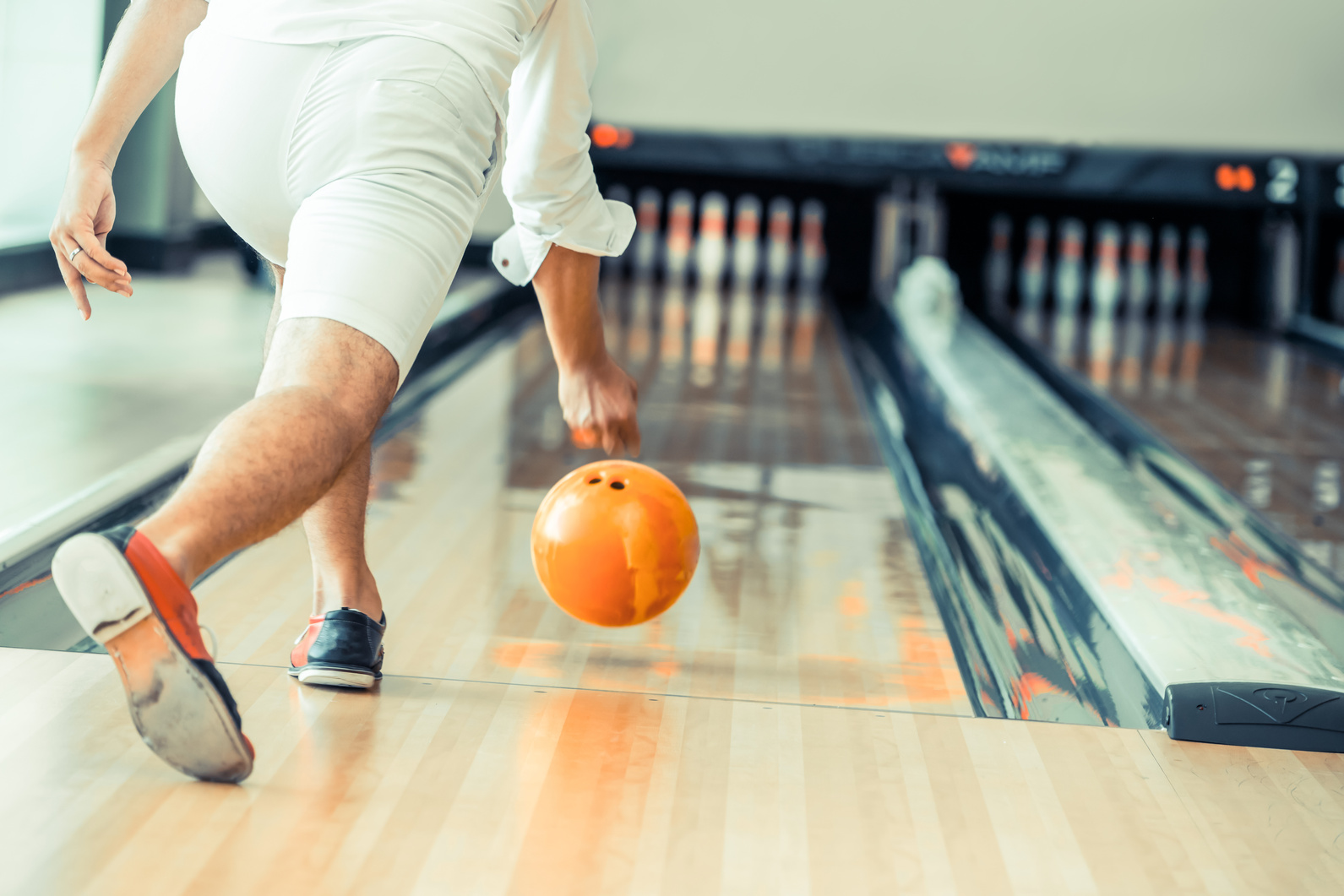 Young man playing bowling.